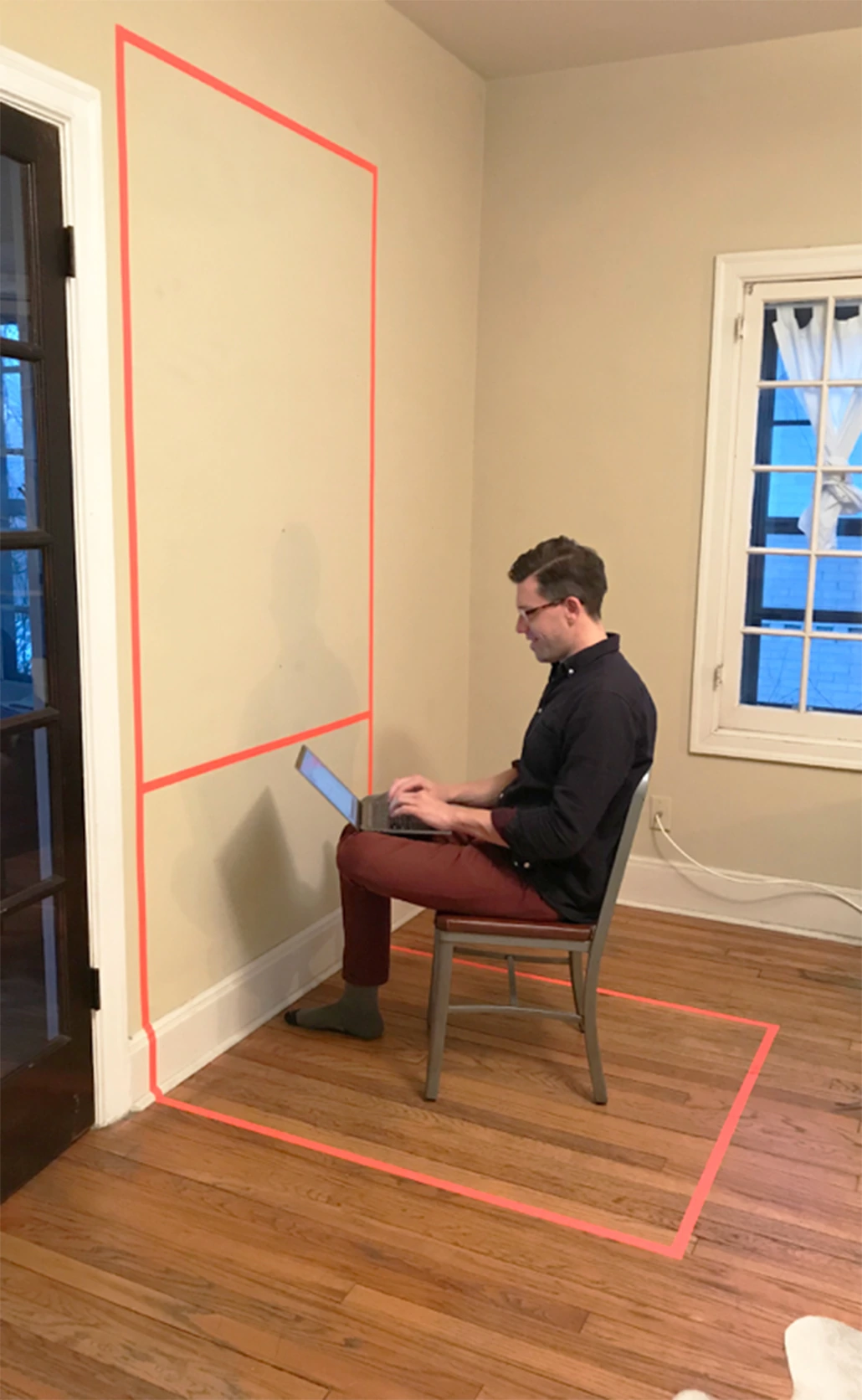 A person testing the feel of working inside a rough booth mockup