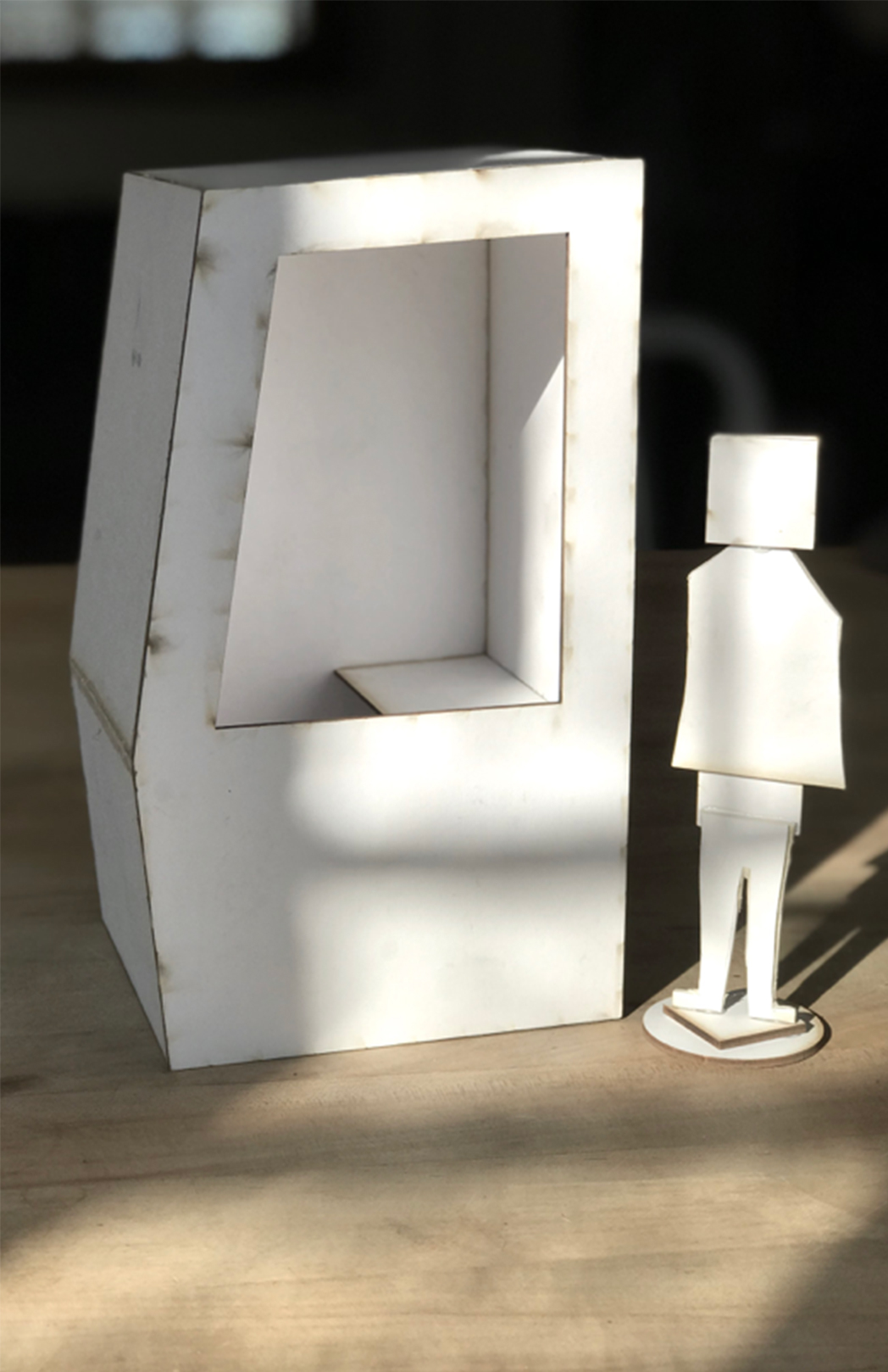 Human-shaped figures placed against 7-inch booth models for scale